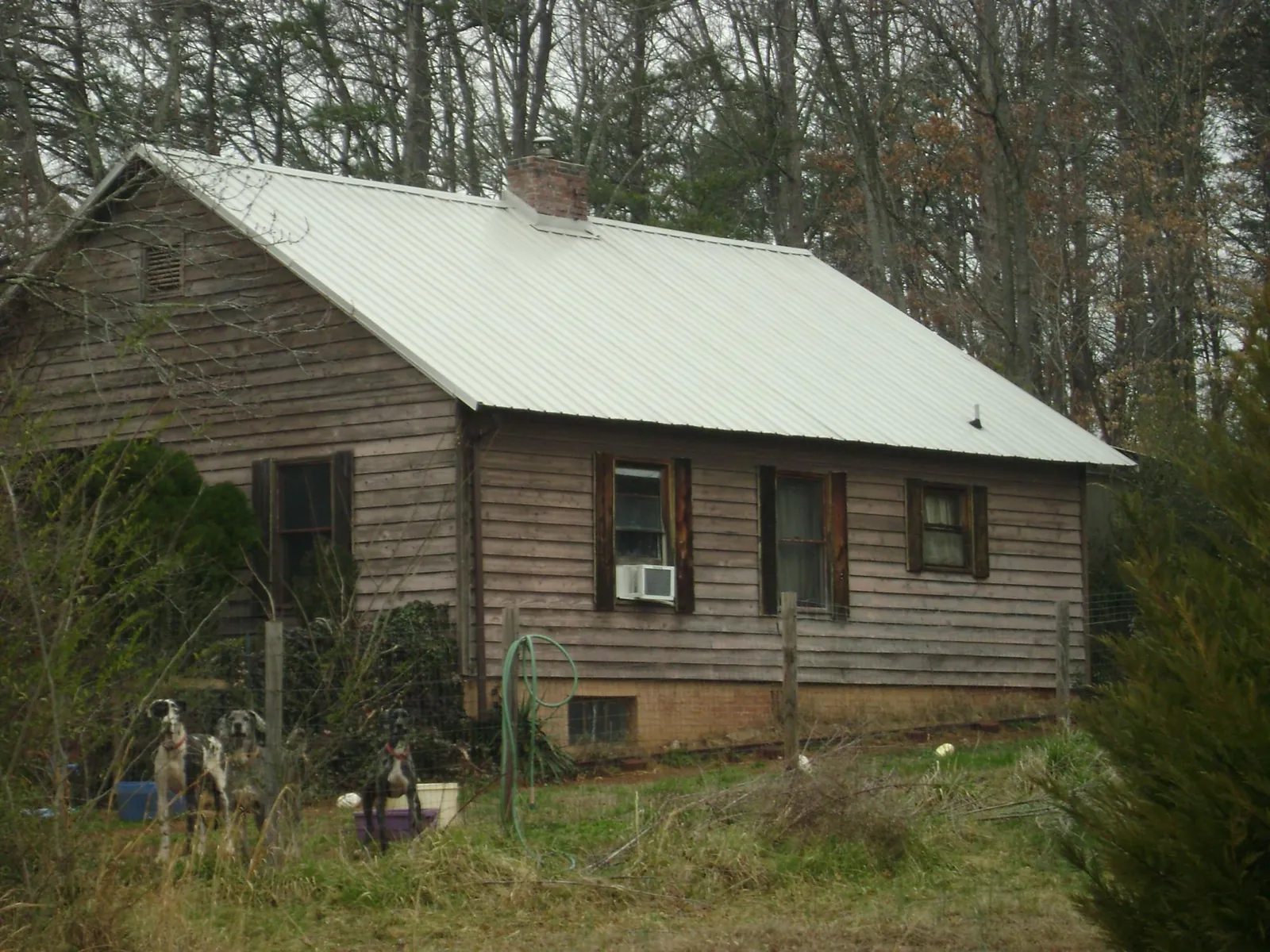White metal roof on an old wood sided farmhouse, from a Metal Roof Installation job in San Ysidro